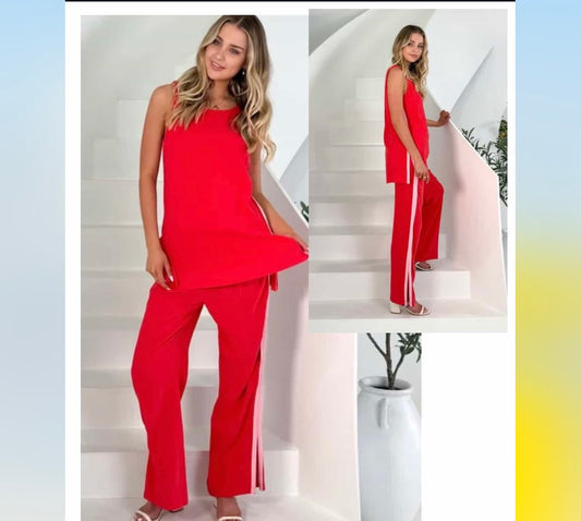 Woman wearing a red outfit with white stripes on a staircase.